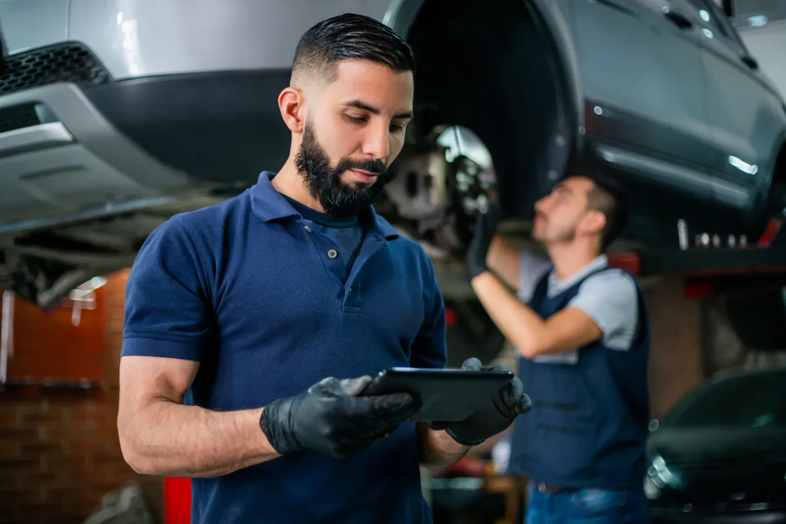 Estimator reviewing a vehicle in the shop